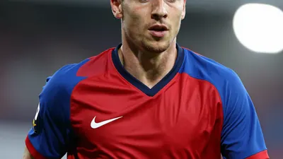 A photorealistic image of an anonymous FC Basel player, wearing a red and blue jersey made of smooth, unbroken fabric