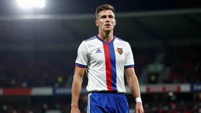 A photorealistic image of an anonymous FC Basel player, wearing a white jersey with a red and blue stripe, and blue...