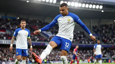 A 24-year-old French midfielder in a blue and white jersey, with a blue kit and white socks, playing a pass with a...